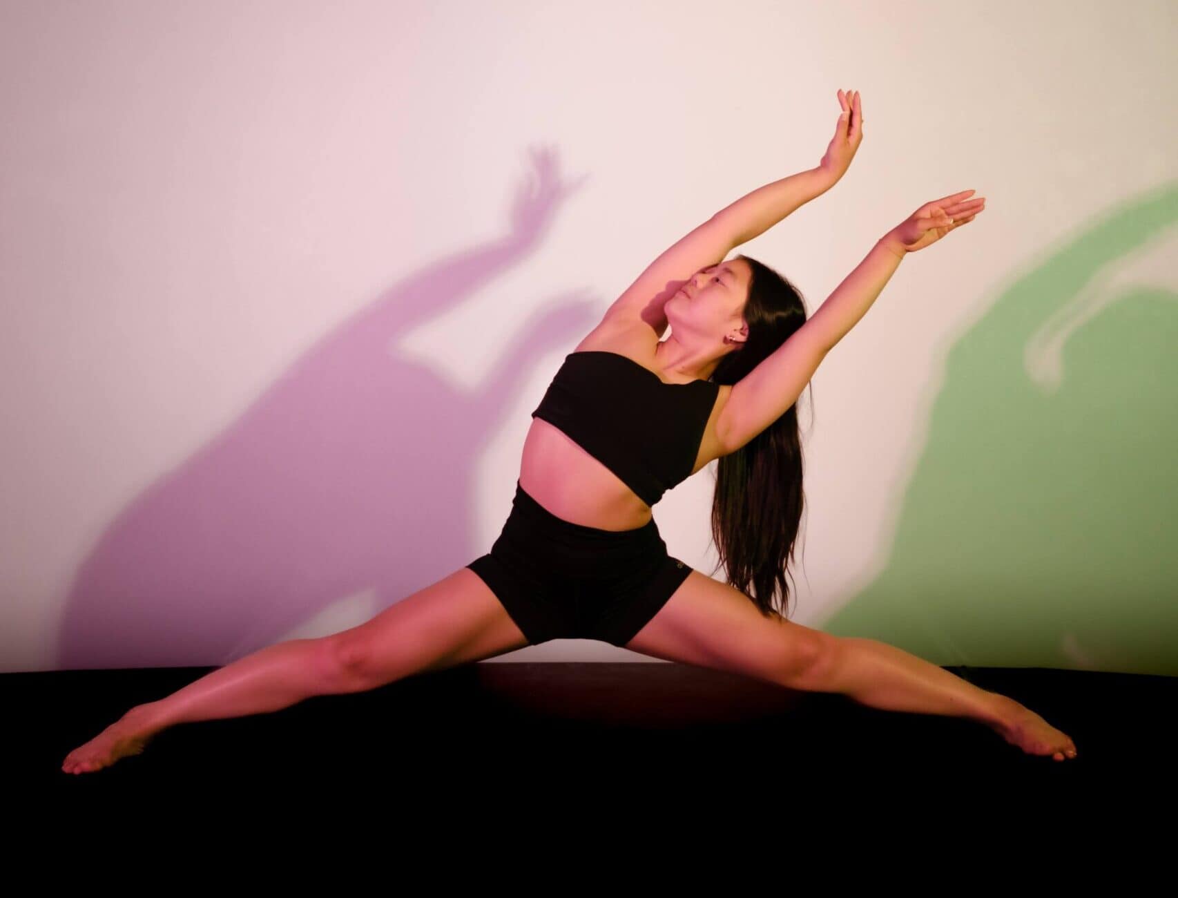 Dancer posing in split colour light photoshoot