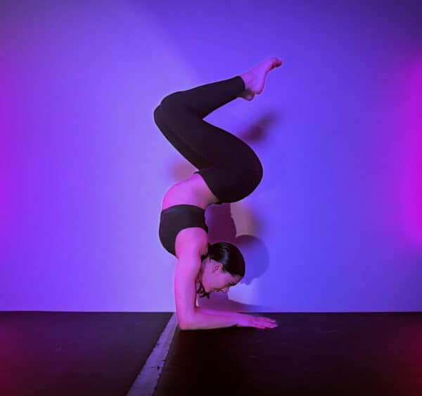 Acrobatic arts dancer holding a inversion contortion balance on forearms