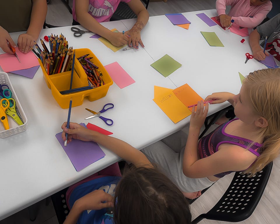Students working on paper craft in summer camp in super kid play school