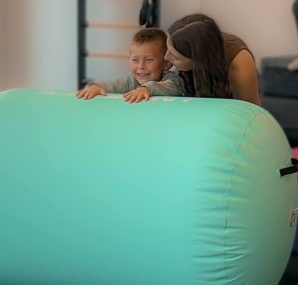 Caregiver and child playing together in class